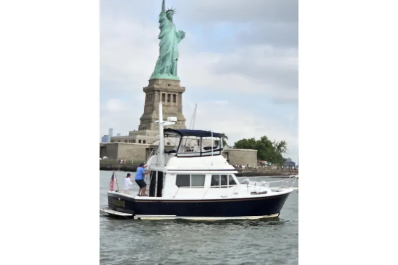 Slide: The Image of Sabre 34 boat near Statue of Liberty, 1999 model, cruising in New York Harbor. - 4