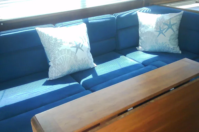 Slide: The Image of Blue cushioned seating with starfish pillows on a 1999 Sabre 34 yacht. - 53