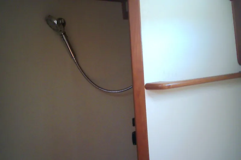 Slide: The Image of Interior of 1999 Sabre 34 yacht showing shower area with wooden trim. - 58