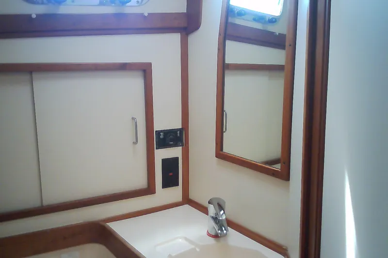 Slide: The Image of Interior of 1999 Sabre 34 yacht bathroom with mirror and sink. - 59