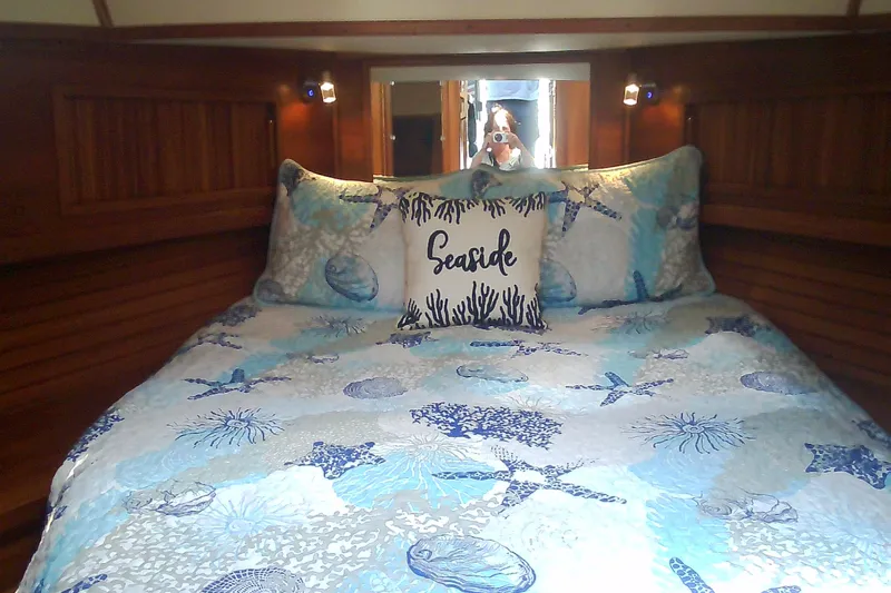 Slide: The Image of Cozy cabin bedroom in 1999 Sabre 34 yacht with seaside-themed bedding. - 61