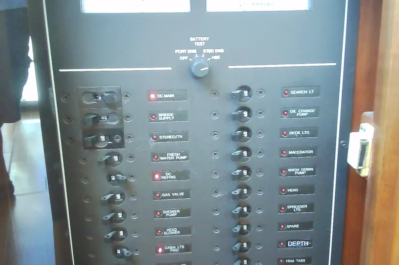 Slide: The Image of Electrical control panel on a 1999 Sabre 34 boat, featuring various switches and labels. - 64