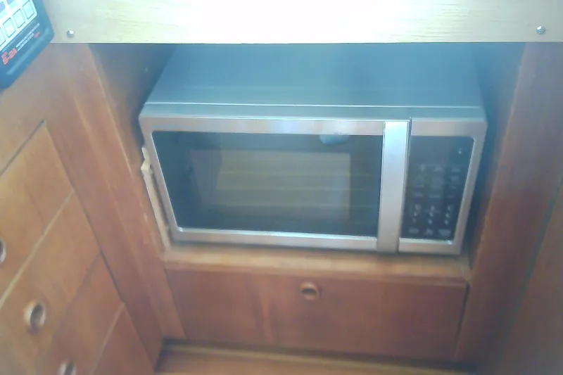 Slide: The Image of Built-in microwave in a 1999 Sabre 34 boat kitchen cabinet. - 67
