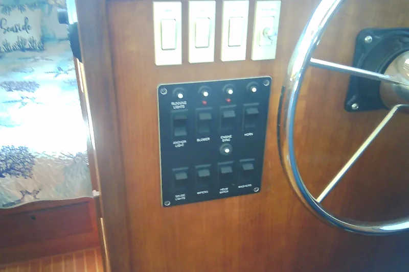 Slide: The Image of Control panel and steering wheel of a 1999 Sabre 34 boat interior. - 79