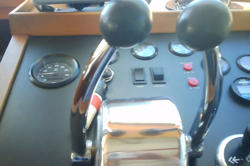 Slide: The Image of Boat control panel with dual throttle levers, gauges, and switches, Sabre 34, 1999 model. - 81