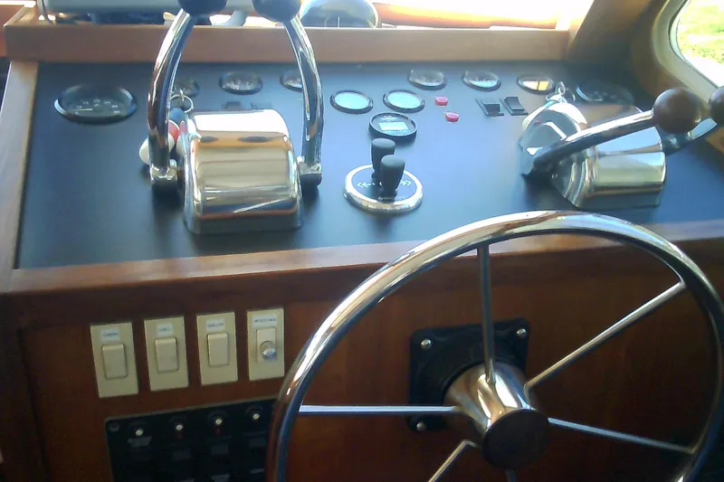 Slide: The Image of Helm of 1999 Sabre 34 boat with steering wheel and control panel. - 82