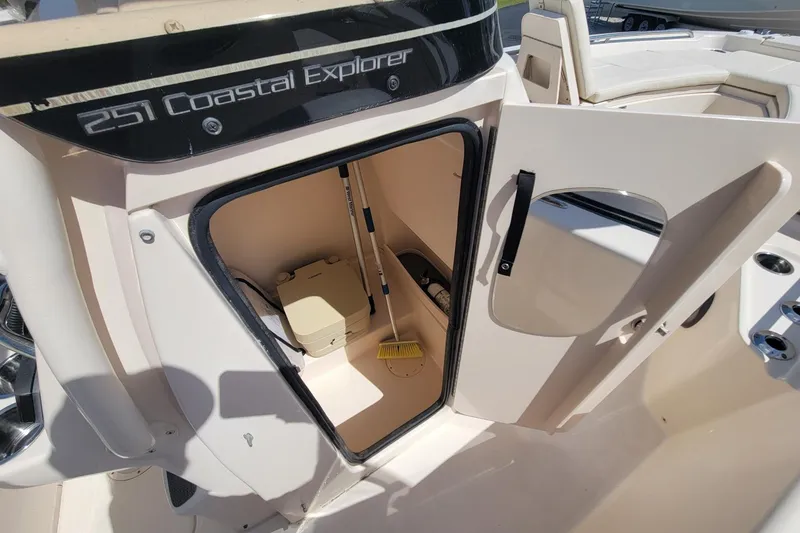 Slide: The Image of 2019 Grady-White 251 Coastal Explorer boat interior with open storage compartment. - 14