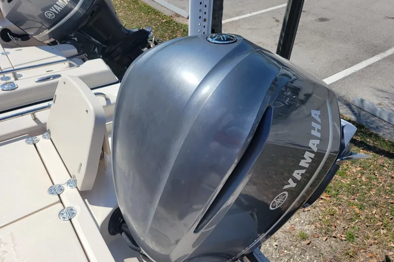 Slide: The Image of 2019 Grady-White 251 Coastal Explorer with Yamaha outboard motor in a parking area. - 15