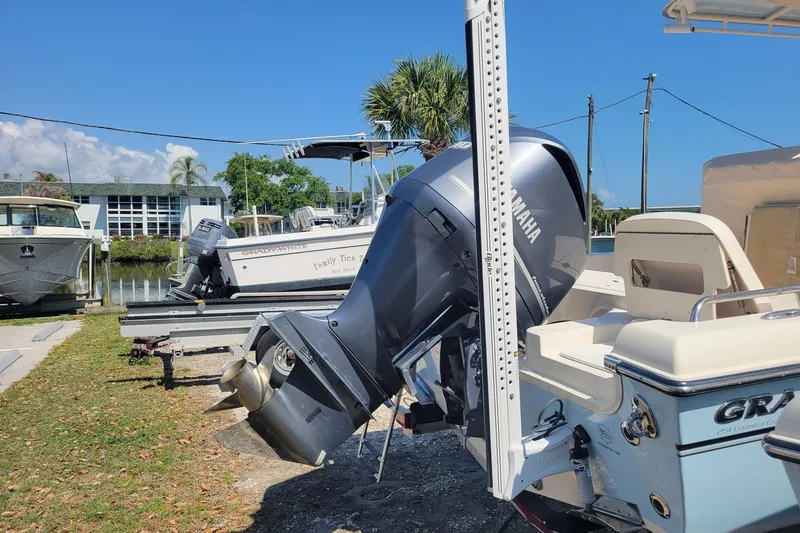 Slide: The Image of 2019 Grady-White 251 Coastal Explorer boat with Yamaha outboard motor docked outdoors. - 16