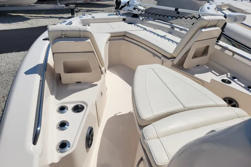 Slide: The Image of 2019 Grady-White 251 Coastal Explorer boat interior with cushioned seating and cup holders. - 3