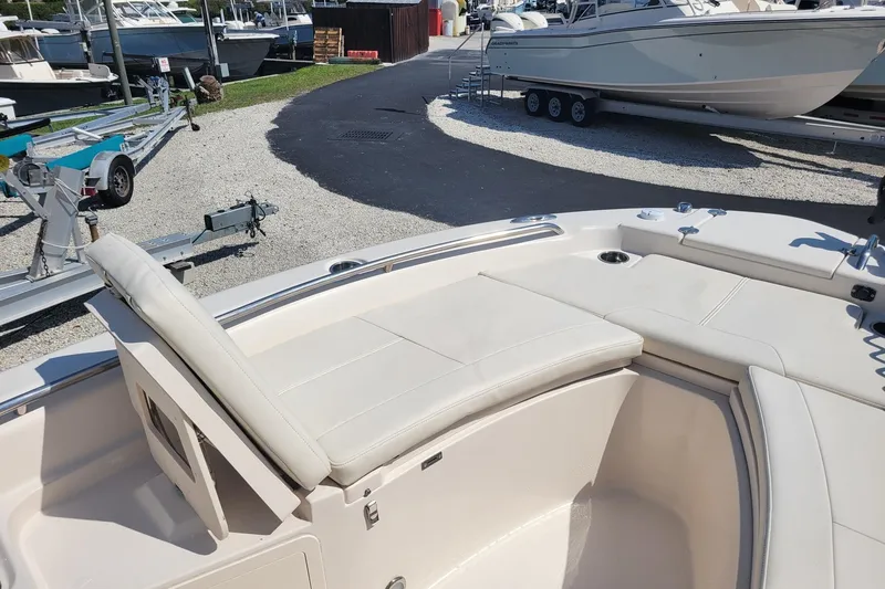 Slide: The Image of 2019 Grady-White 251 Coastal Explorer boat interior with cushioned seating. - 7