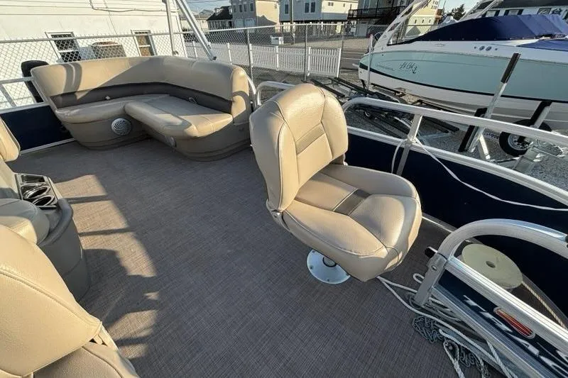 Slide: The Image of 2022 Sun Tracker Bass Buggy 16 XL pontoon boat interior with beige seating. - 10