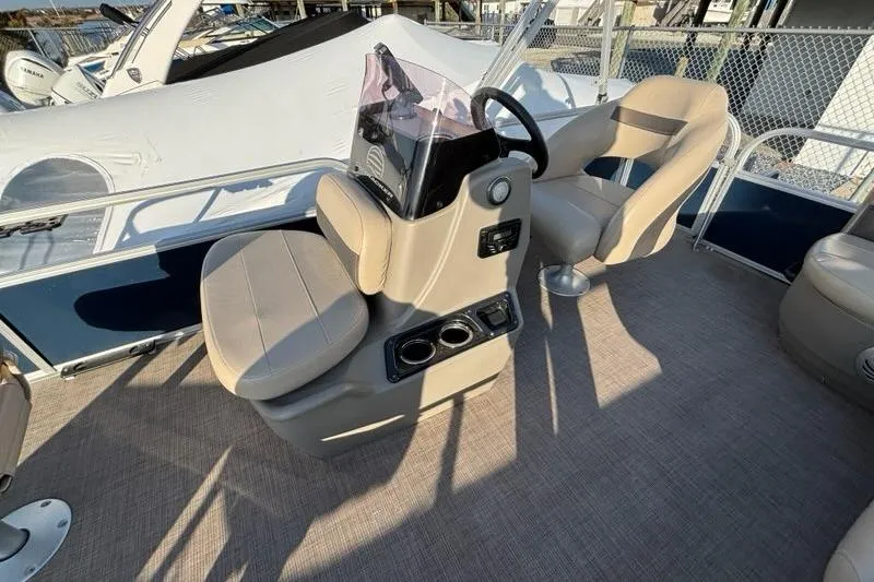 Slide: The Image of 2022 Sun Tracker Bass Buggy 16 XL interior with helm and seating area. - 11