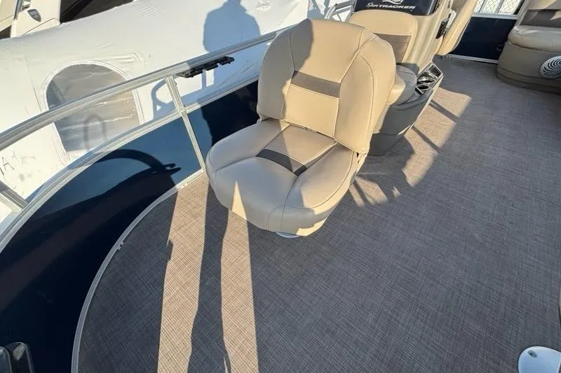 Slide: The Image of 2022 Sun Tracker Bass Buggy 16 XL boat interior with beige seating and carpeted floor. - 13