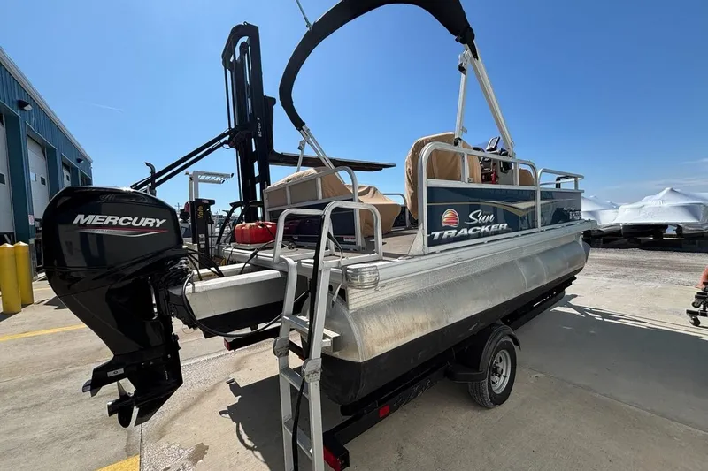 Slide: The Image of 2022 Sun Tracker Bass Buggy 16 XL pontoon boat with Mercury outboard motor on trailer. - 4