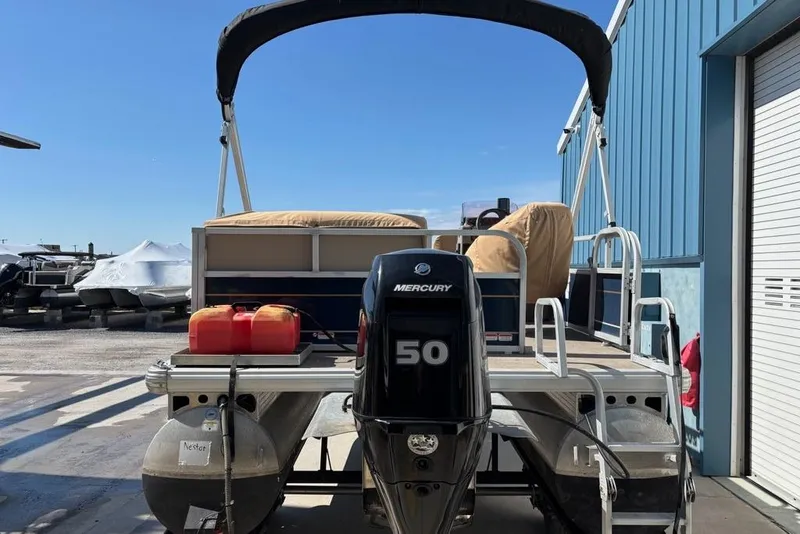 Slide: The Image of 2022 Sun Tracker Bass Buggy 16 XL pontoon boat with Mercury 50 engine, docked outdoors. - 6