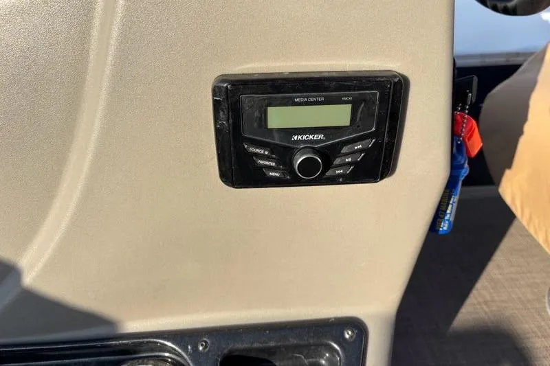 Slide: The Image of Kicker media center on 2022 Sun Tracker Bass Buggy 16 XL boat dashboard. - 9
