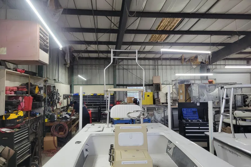 Slide: The Image of 2026 Mitzi Skiffs 17 Tournament boat in a workshop with tools and equipment. - 1