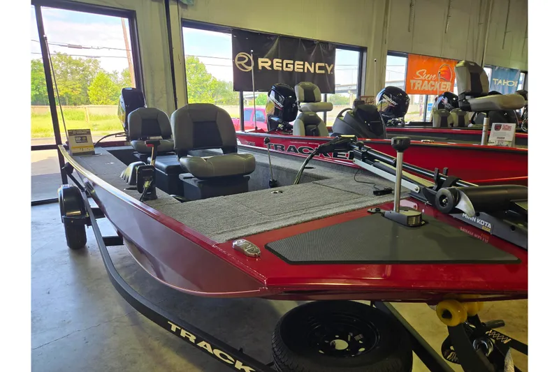 Slide: The Image of 2026 Tracker Panfish 17 boat in showroom, featuring red exterior and comfortable seating. - 47