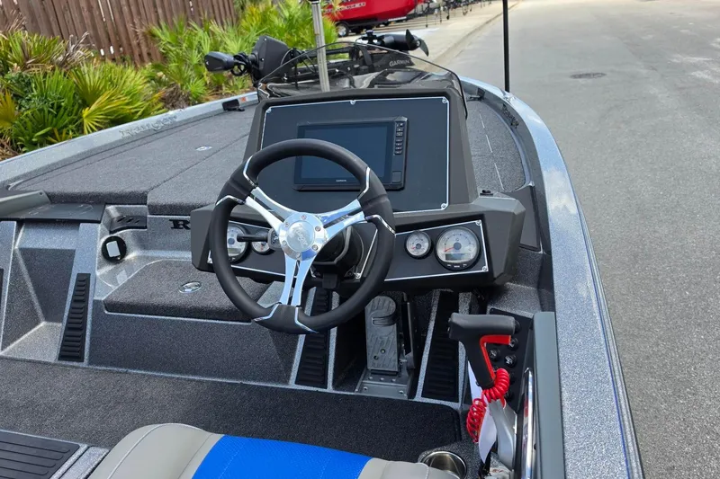 Slide: The Image of 2026 Ranger Z518 Cup-Equipped boat dashboard with steering wheel and navigation display. - 12