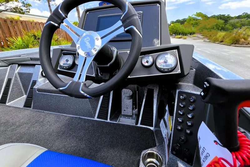 Slide: The Image of 2026 Ranger Z518 Cup-Equipped boat dashboard with steering wheel and control panel. - 14