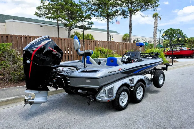 Slide: The Image of 2026 Ranger Z518 Cup-Equipped boat with powerful engine, parked outdoors. - 2