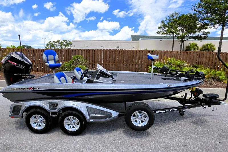 Slide: The Image of 2026 Ranger Z518 Cup-Equipped boat with trailer, parked outdoors under a blue sky. - 6