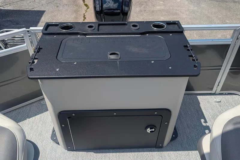 Slide: The Image of 2026 Sun Tracker Fishin' Barge 20 DLX fishing station with storage and cup holders. - 2