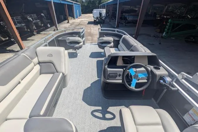 Slide: The Image of 2026 Sun Tracker Fishin' Barge 20 DLX pontoon boat with spacious seating and modern helm. - 3