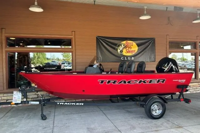 The Image of 2026 Tracker Pro Guide V-16 SC boat in vibrant red on display at Bass Pro Shops. - 0