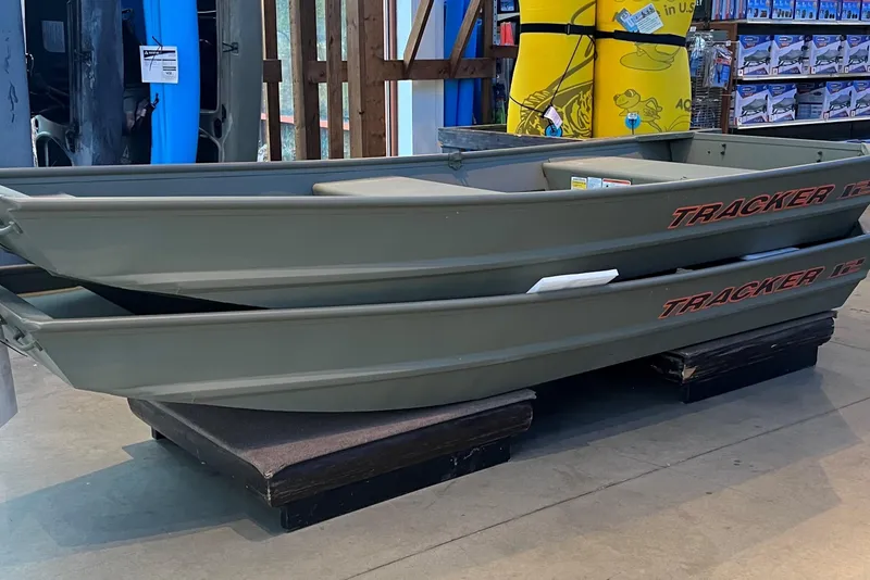 The Image of 2026 Tracker Grizzly 12 Jon boats stacked in a showroom display. - 0