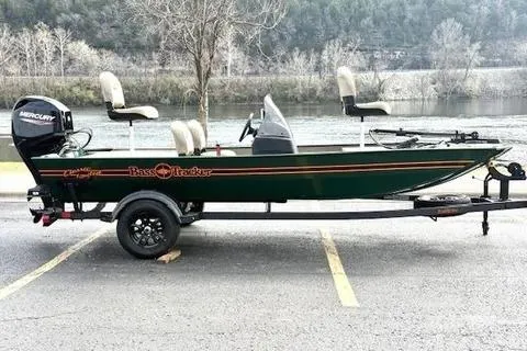 Slide: The Image of 2026 Tracker Bass Tracker Classic Limited boat with Mercury engine, parked near a river. - 61