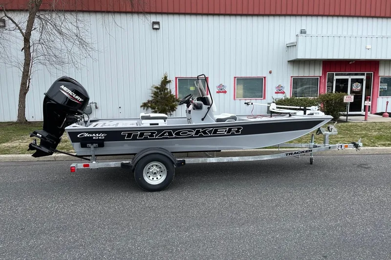 The Image of 2026 Tracker Bass Tracker Classic CC boat on trailer outside a building. - 0