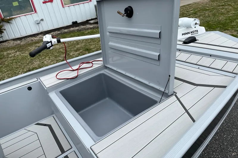 Slide: The Image of 2026 Tracker Bass Tracker Classic CC boat with open storage compartment and Minn Kota trolling motor. - 12