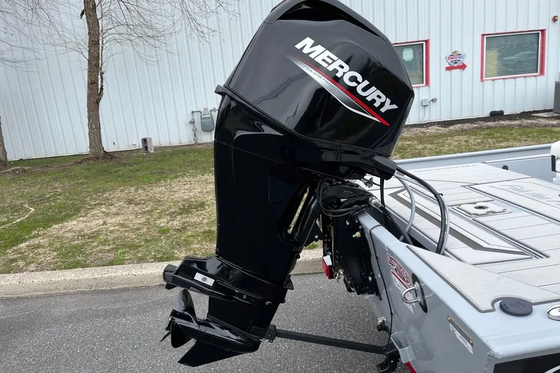 Slide: The Image of 2026 Tracker Bass Tracker Classic CC with Mercury outboard motor, parked outdoors. - 5