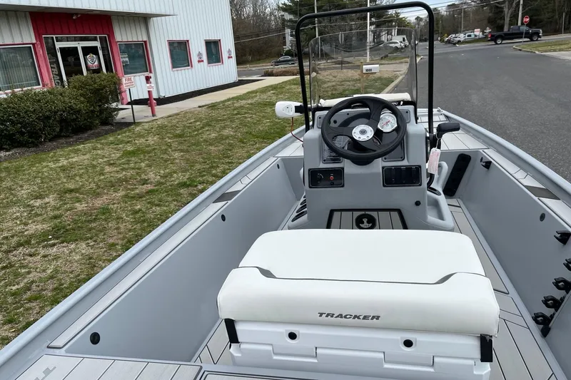 Slide: The Image of 2026 Tracker Bass Tracker Classic CC boat interior with steering wheel and seating. - 6
