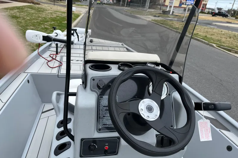 Slide: The Image of 2026 Tracker Bass Tracker Classic CC boat interior with steering wheel and controls. - 7