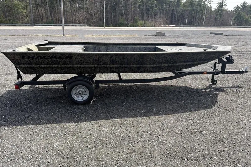 Slide: The Image of 2026 Tracker Grizzly 1648 Utility boat on trailer in parking lot. - 2