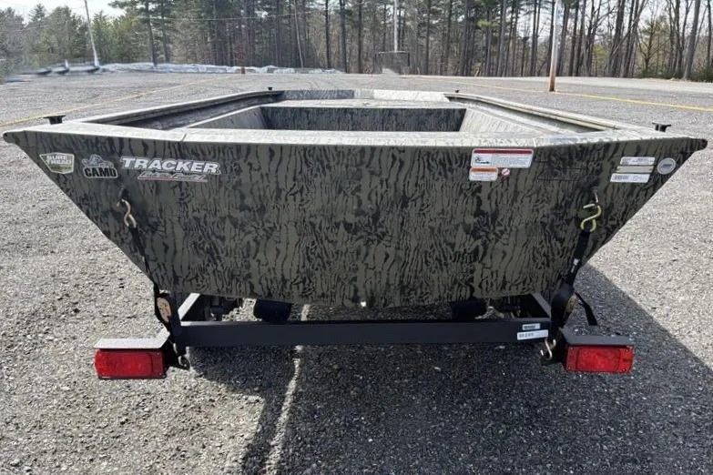 Slide: The Image of 2026 Tracker Grizzly 1648 Utility boat with camouflage design on a trailer. - 6