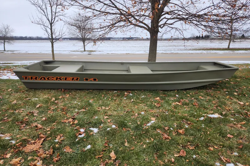 The Image of 2026 Tracker Grizzly 14 Jon boat on grass with snowy background. - 0