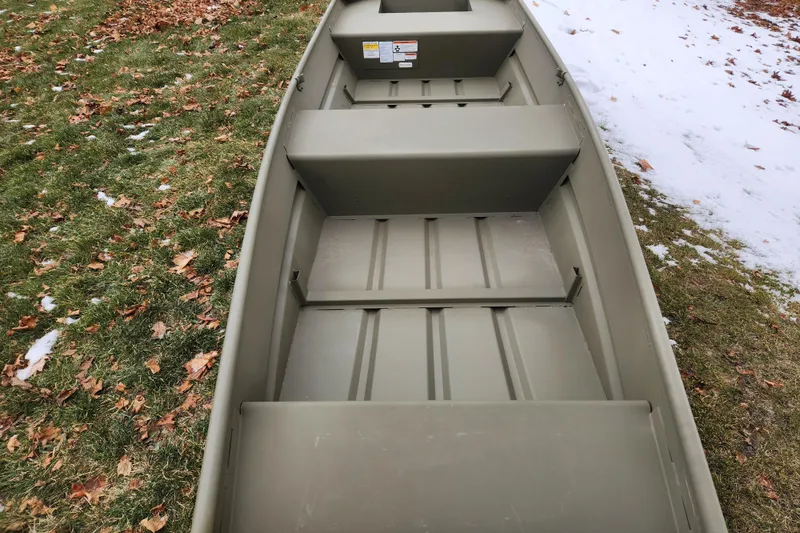 Slide: The Image of 2026 Tracker Grizzly 14 Jon boat on grass with snow and leaves. - 4