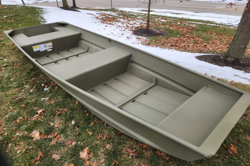 Slide: The Image of 2026 Tracker Grizzly 14 Jon boat on grass with snow and leaves. - 5