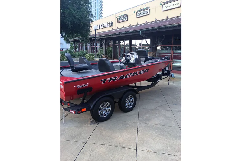The Image of 2026 Tracker Pro Team 195 boat on trailer outside dealership. - 0