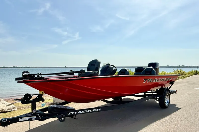 Slide: The Image of 2026 Tracker Pro Team 195 boat in vibrant red by a serene lakeside. - 63