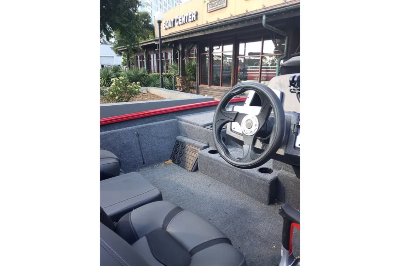 Slide: The Image of Interior of 2026 Tracker Pro Team 195 boat with steering wheel and seating. - 65