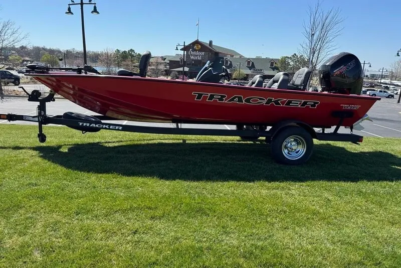 Slide: The Image of Red 2026 Tracker Pro Team 195 boat on trailer, parked on grass. - 64
