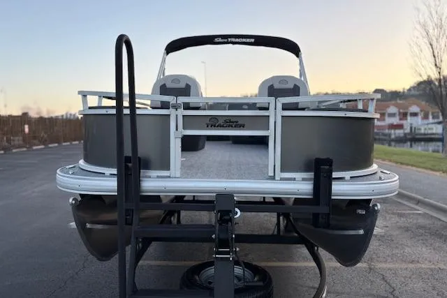 Slide: The Image of 2026 Sun Tracker Bass Buggy 18 DLX pontoon boat on trailer at sunset. - 104