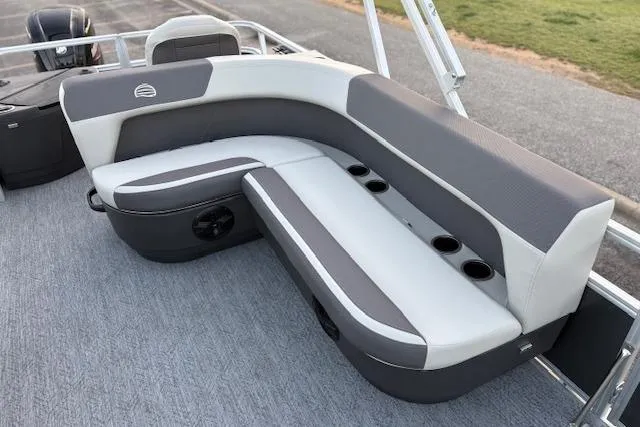 Slide: The Image of 2026 Sun Tracker Bass Buggy 18 DLX pontoon boat seating with cup holders and gray upholstery. - 15