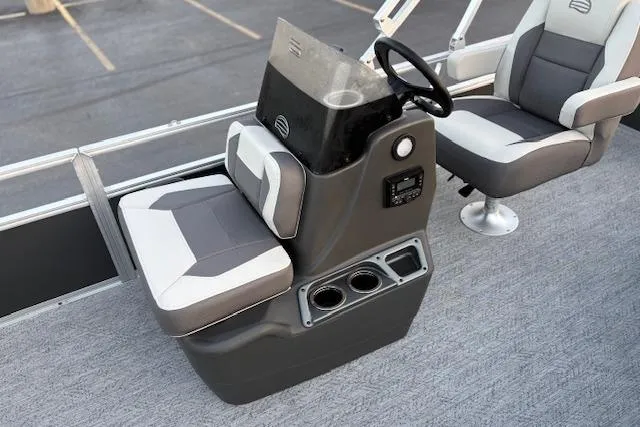 Slide: The Image of 2026 Sun Tracker Bass Buggy 18 DLX boat interior with steering console and seating. - 16