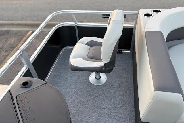 Slide: The Image of 2026 Sun Tracker Bass Buggy 18 DLX boat interior with swivel seat and cup holders. - 18